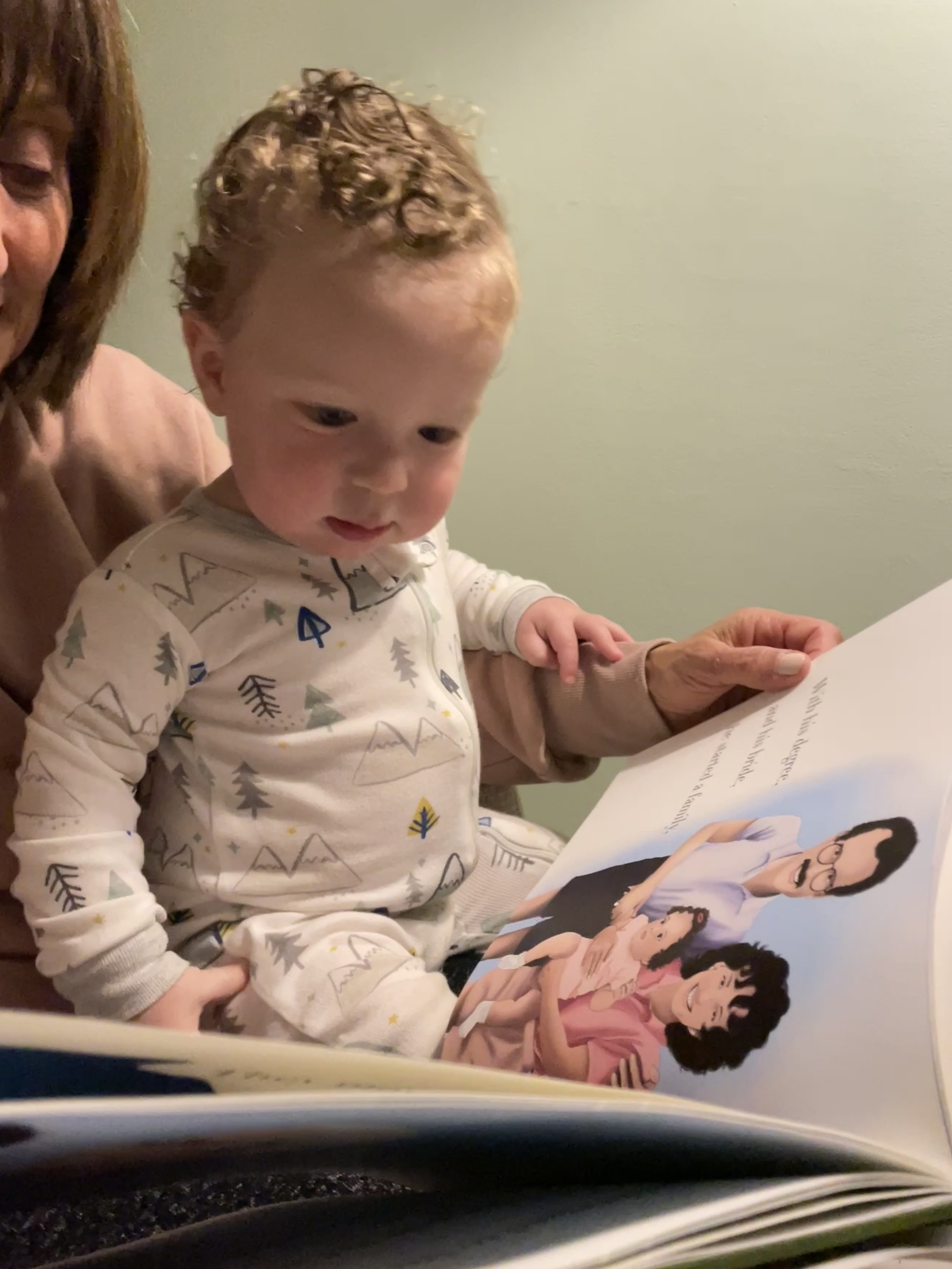 A child looking at an illustrated page of their Opa book
